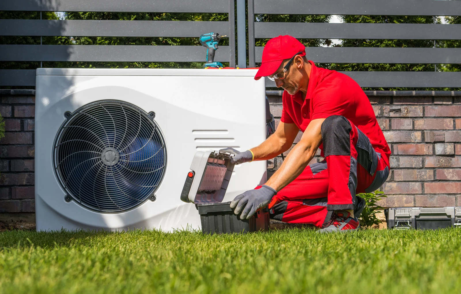 Image of a professional installing a heat pump.