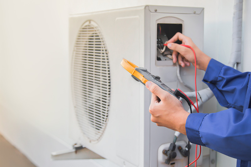 HVAC Technician checking refrigerant level for heat pump in Burnaby