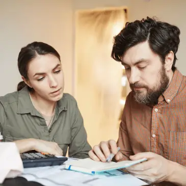 A couple calculating the costs of HVAC services