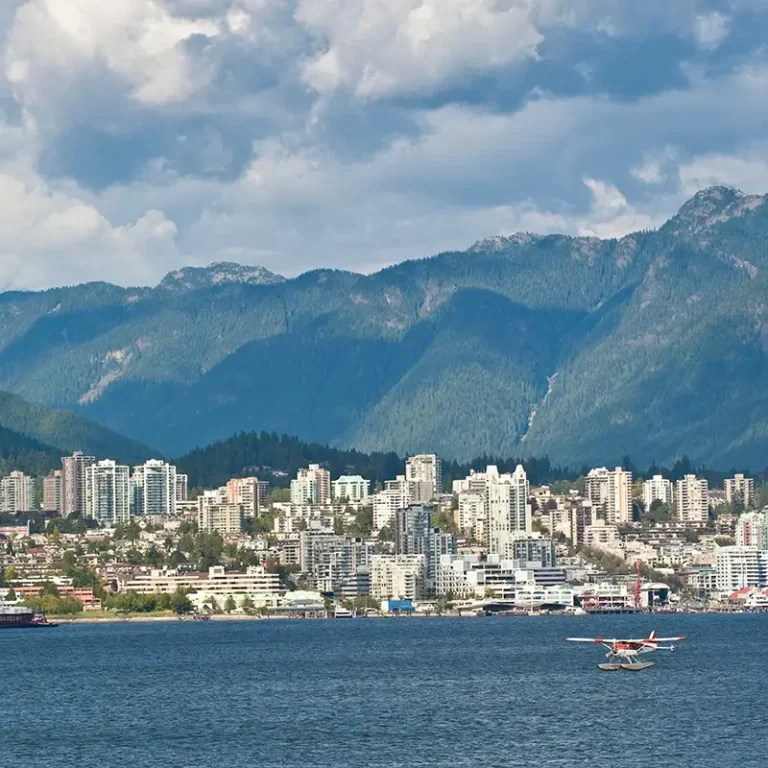 A view of North Vancouver from the water with the mountains in the background